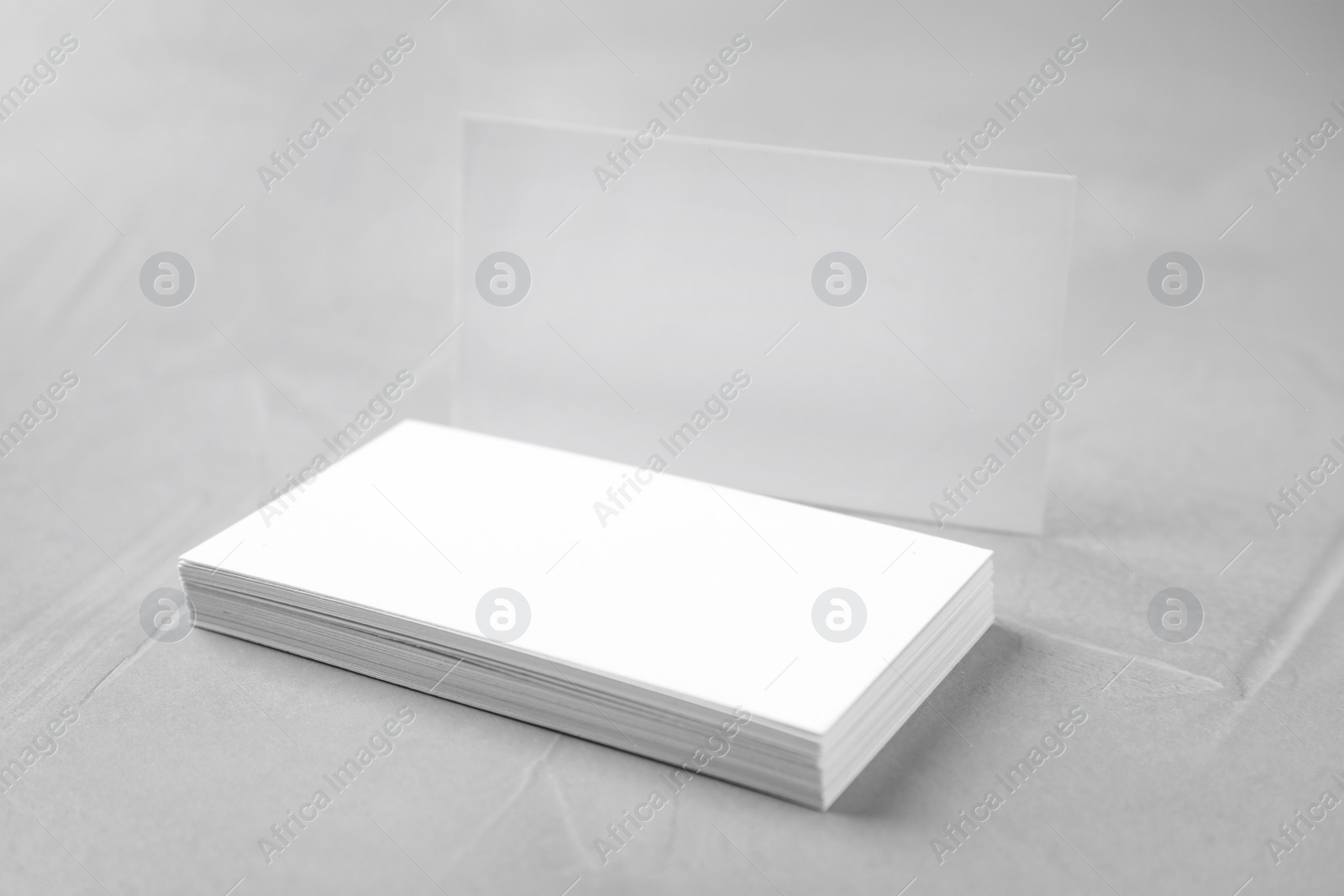 Photo of Stack of empty sheets on grey stone table. Mock up for design