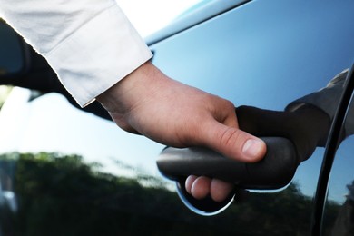 Closeup view of man opening car door