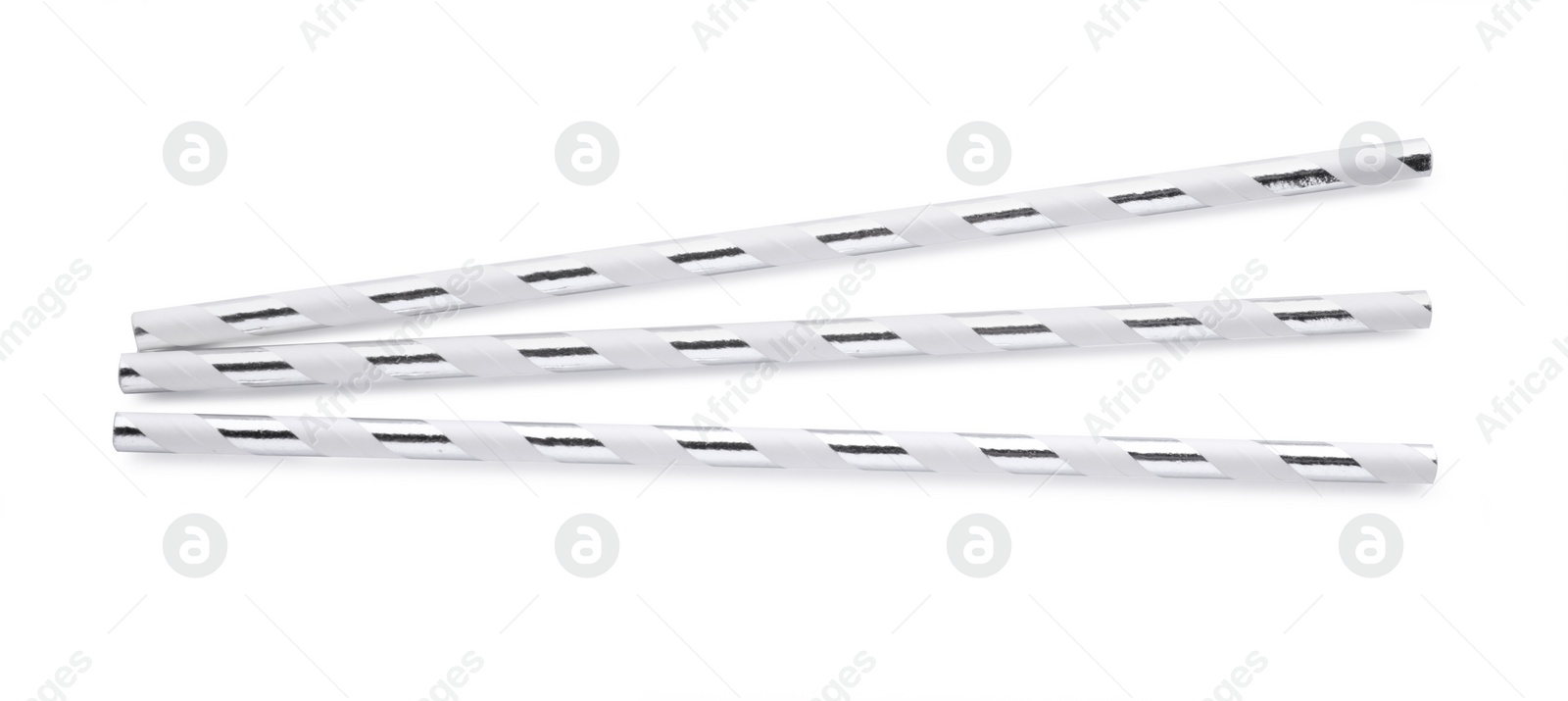 Photo of Striped paper cocktail straws on white background, top view