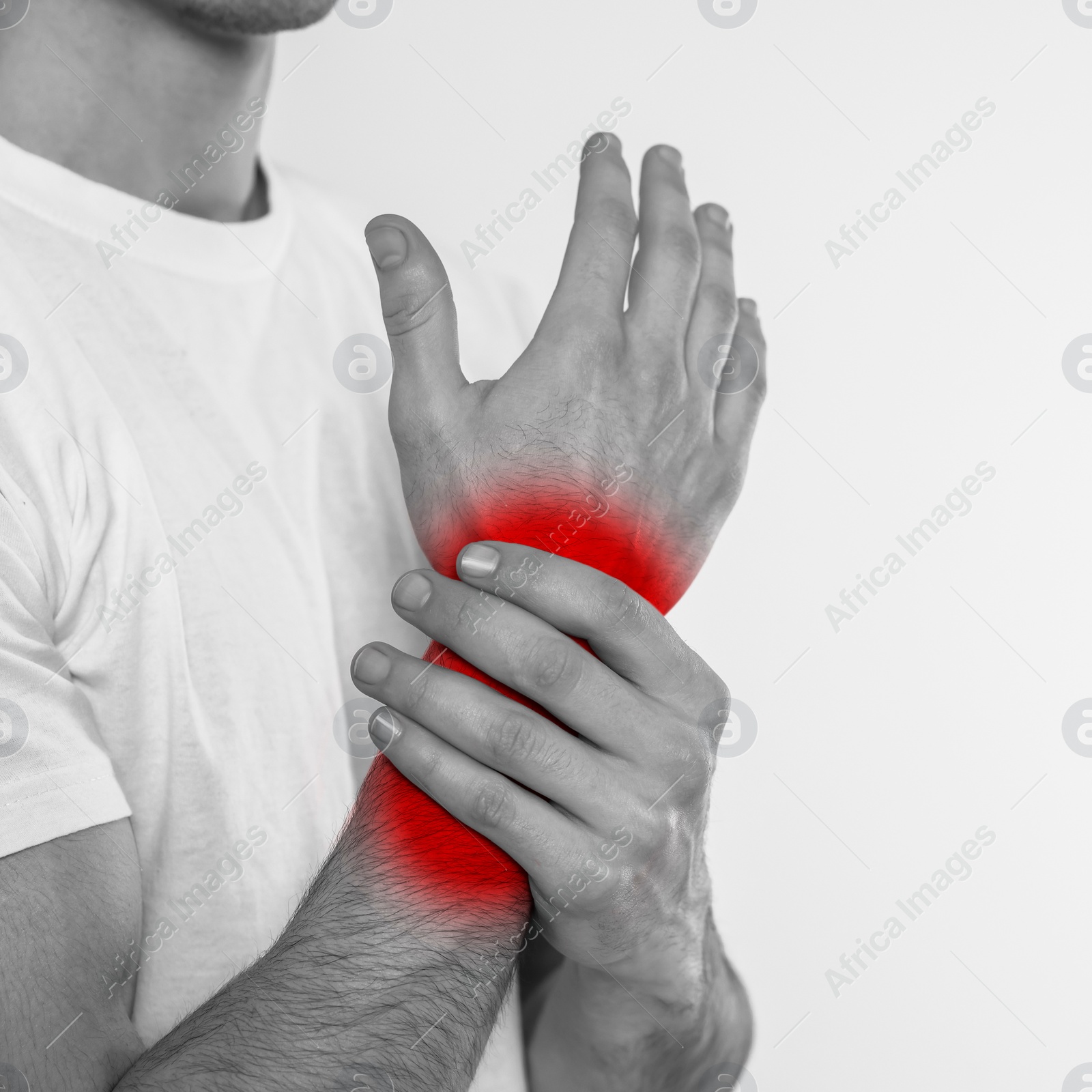 Image of Man suffering from rheumatism, closeup. Black and white effect with red accent in painful area