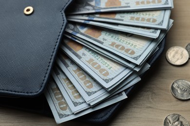 Dollar banknotes, coins and wallet on wooden table, closeup. Money exchange