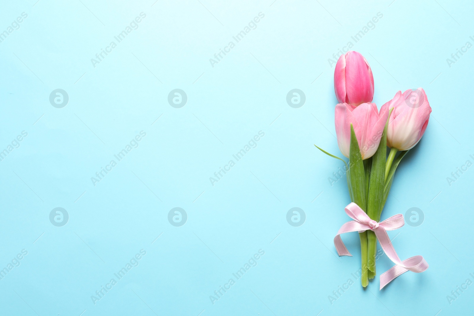 Photo of Beautiful spring tulips on color background, top view with space for text. International Women's Day