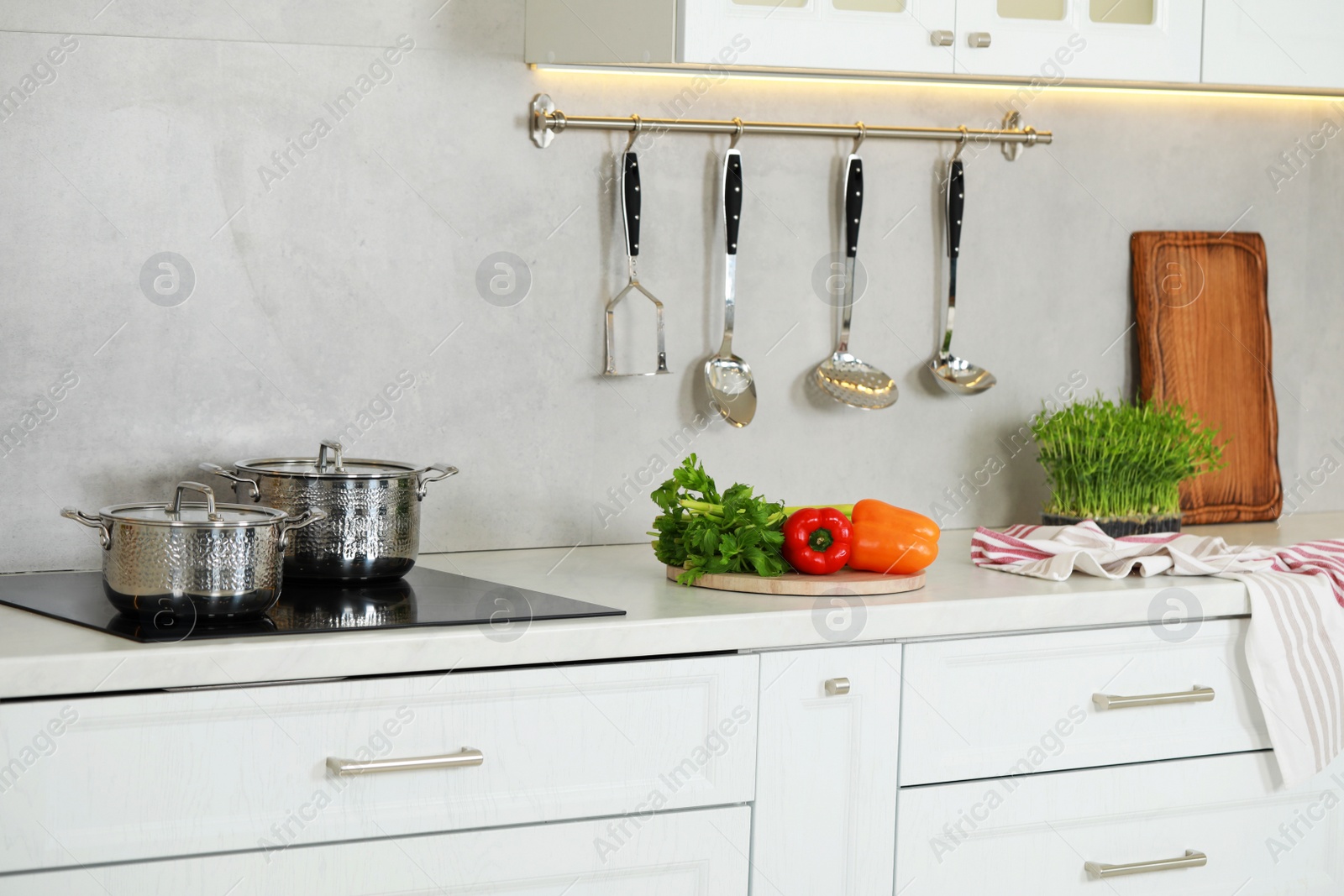 Photo of Countertop with different cooking utensils and ingredients in kitchen