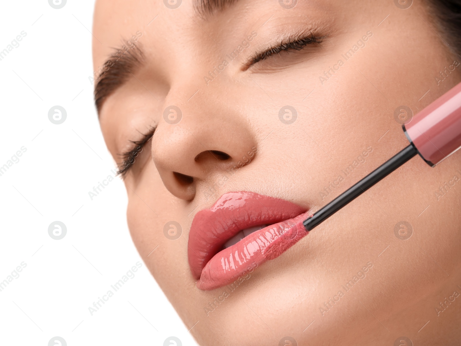 Photo of Woman applying lip gloss on white background, closeup