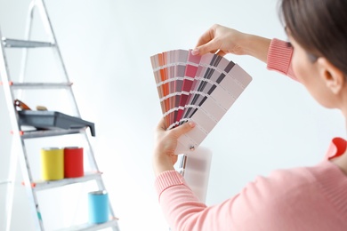 Young woman with color palette on white background, closeup