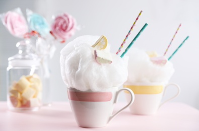 Photo of Tasty cotton candy dessert served on table