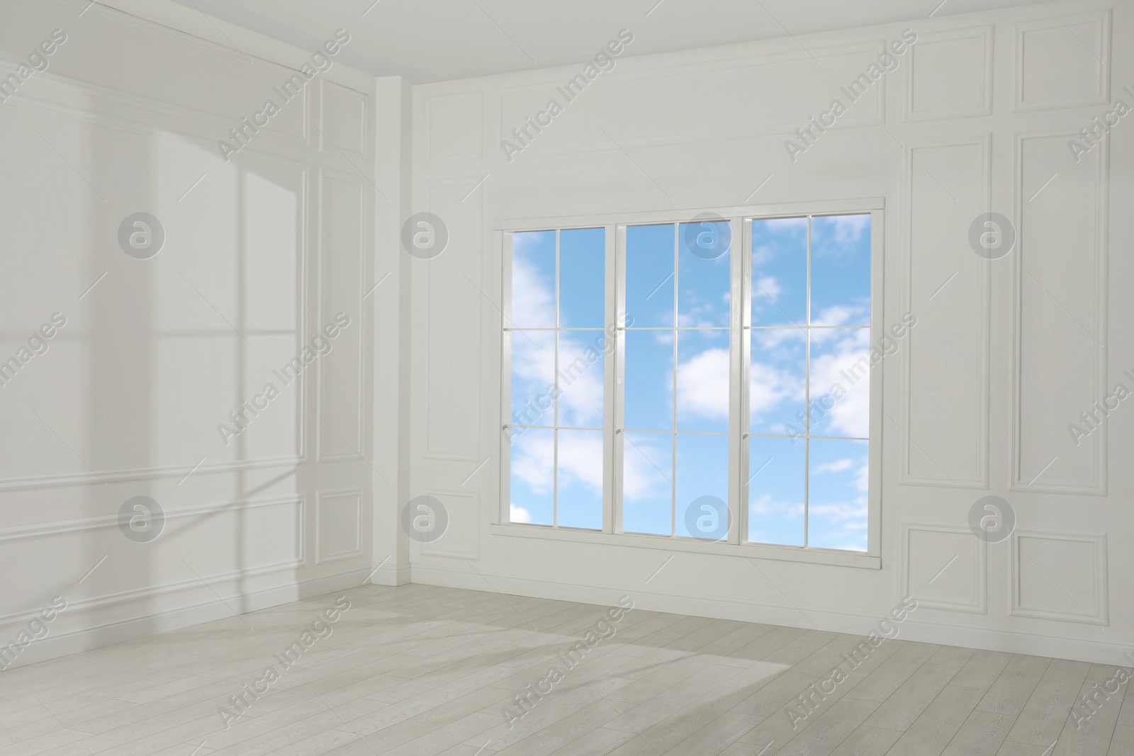 Photo of Empty room with white walls and large window