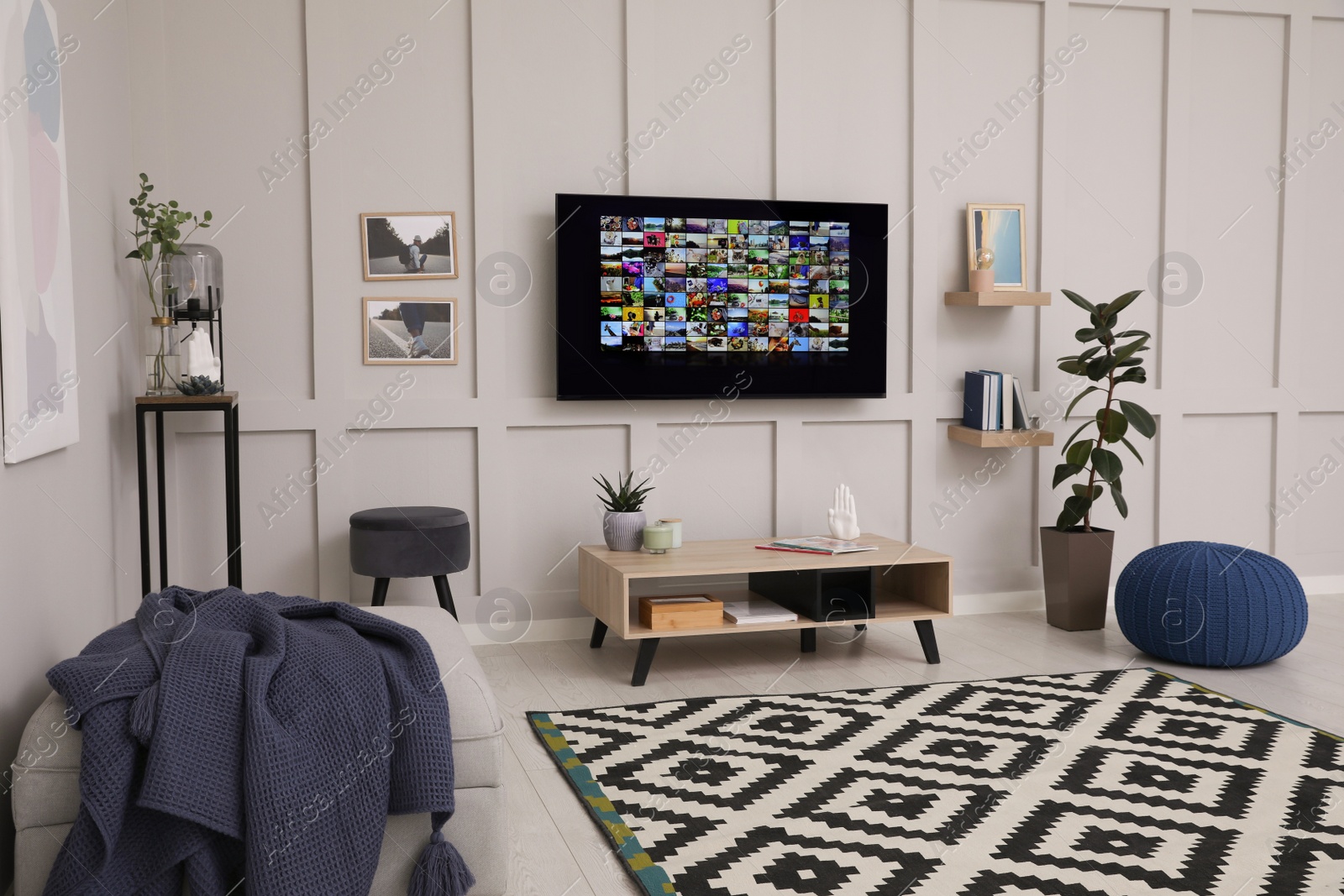 Photo of Stylish living room interior with modern TV on white wall