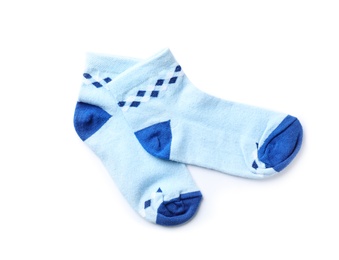 Photo of Cute child socks on white background, top view