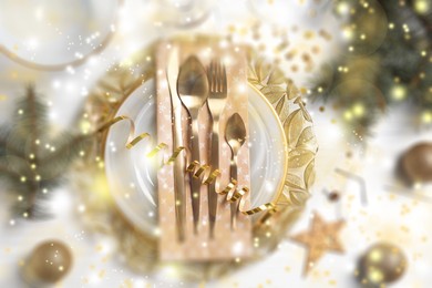 Image of Christmas place setting for festive dinner on white table, flat lay. Bokeh effect