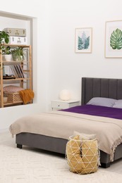Photo of Comfortable bed with purple linens in bedroom. Interior design