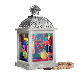 Decorative Arabic lantern and prayer beads on white background