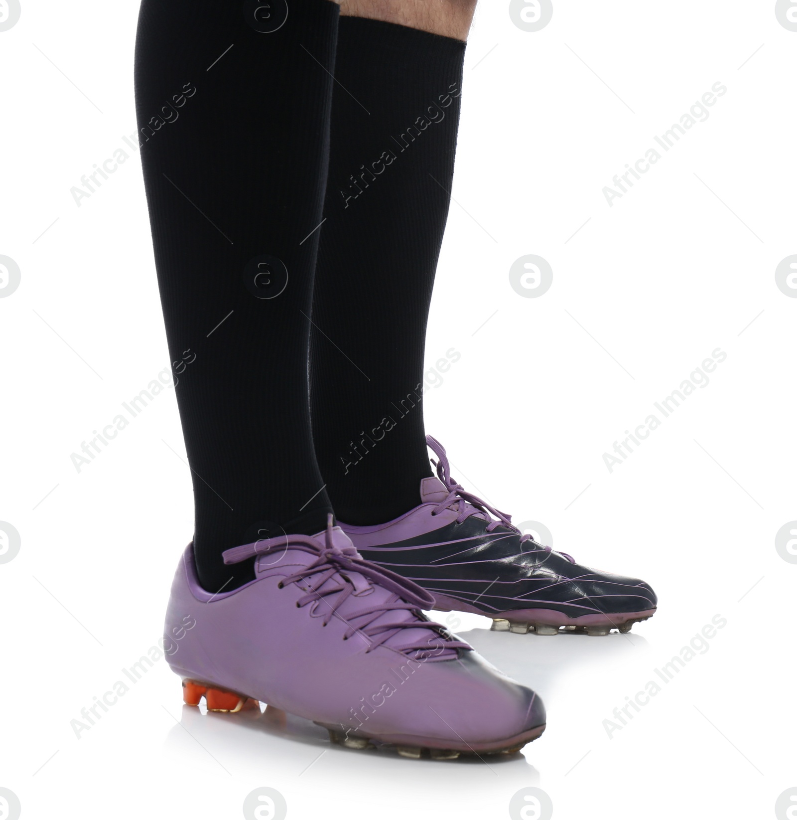 Photo of American football player in uniform on white background, closeup of legs