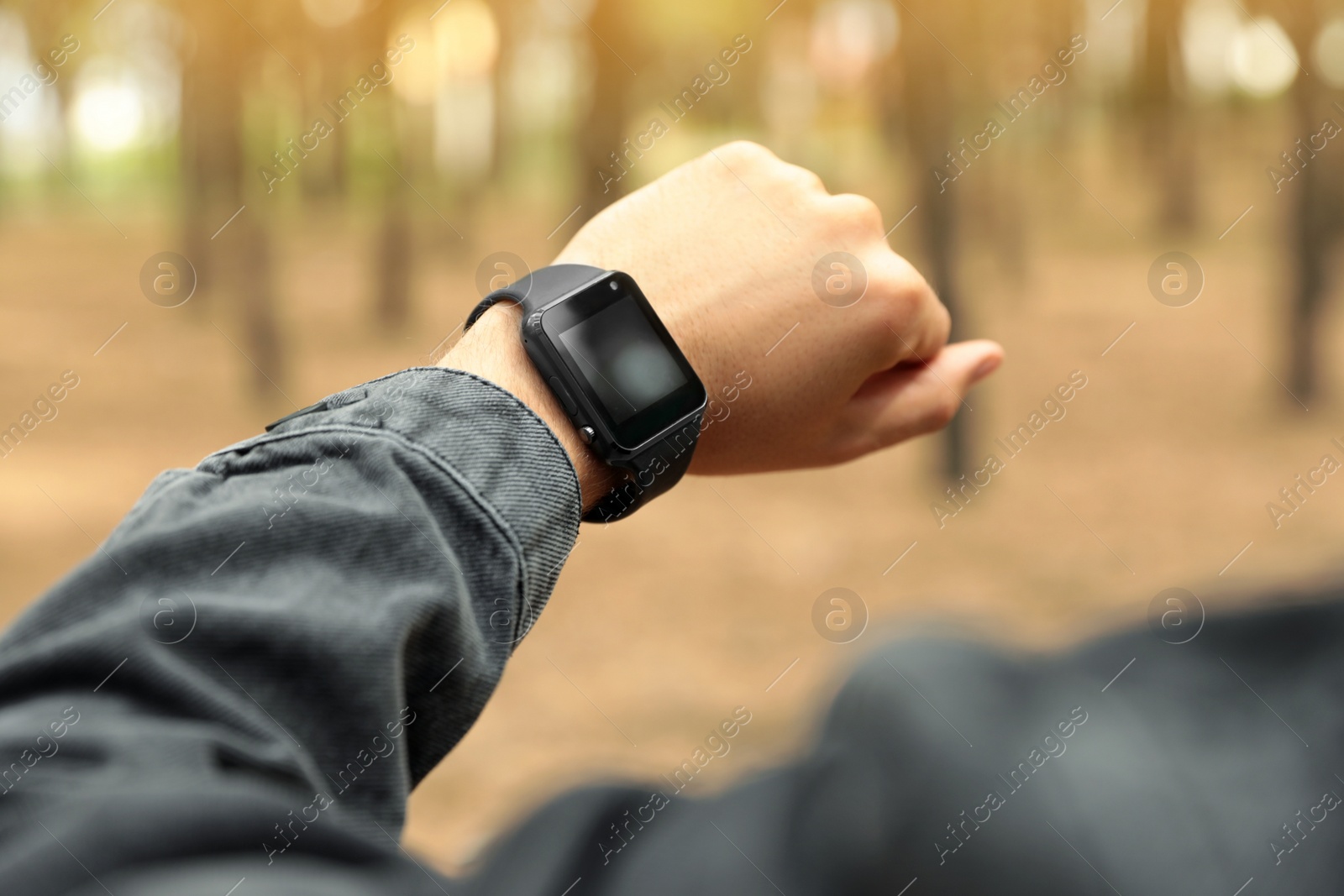 Photo of Man with stylish smart watch outdoors, closeup