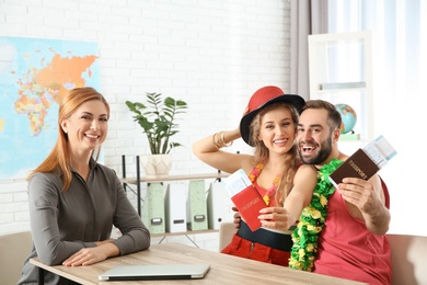 Photo of Beautiful young couple visiting travel agency office