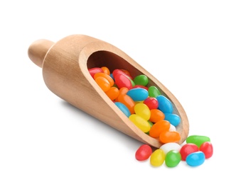 Wooden scoop of tasty jelly beans on white background