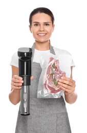 Photo of Beautiful young woman holding sous vide cooker and meat in vacuum pack on white background