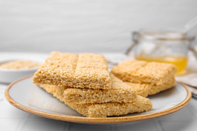 Plate with delicious sesame kozinaki bars on white table, closeup