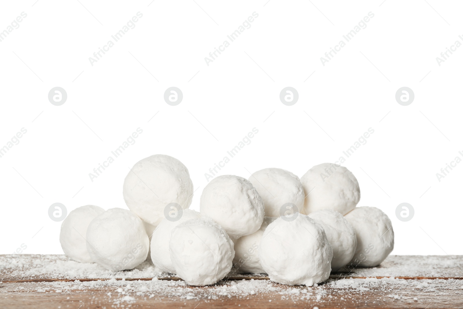 Photo of Snowballs on wooden table against white background