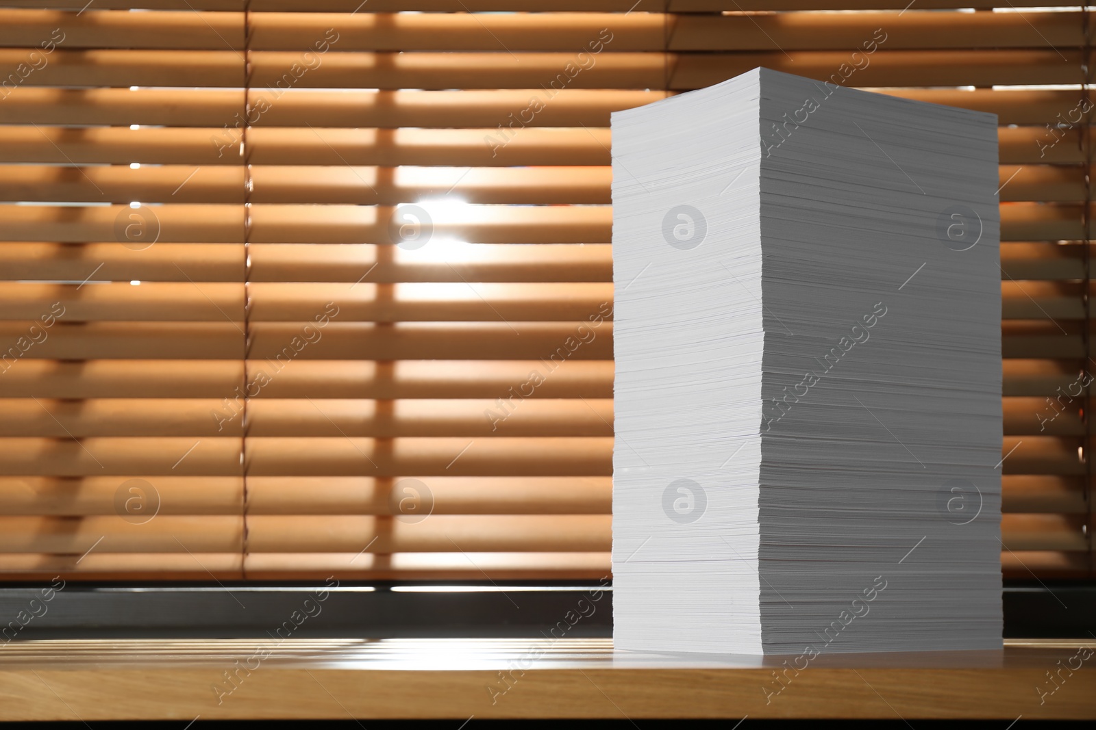 Photo of Stack of paper sheets on wooden table. Space for text