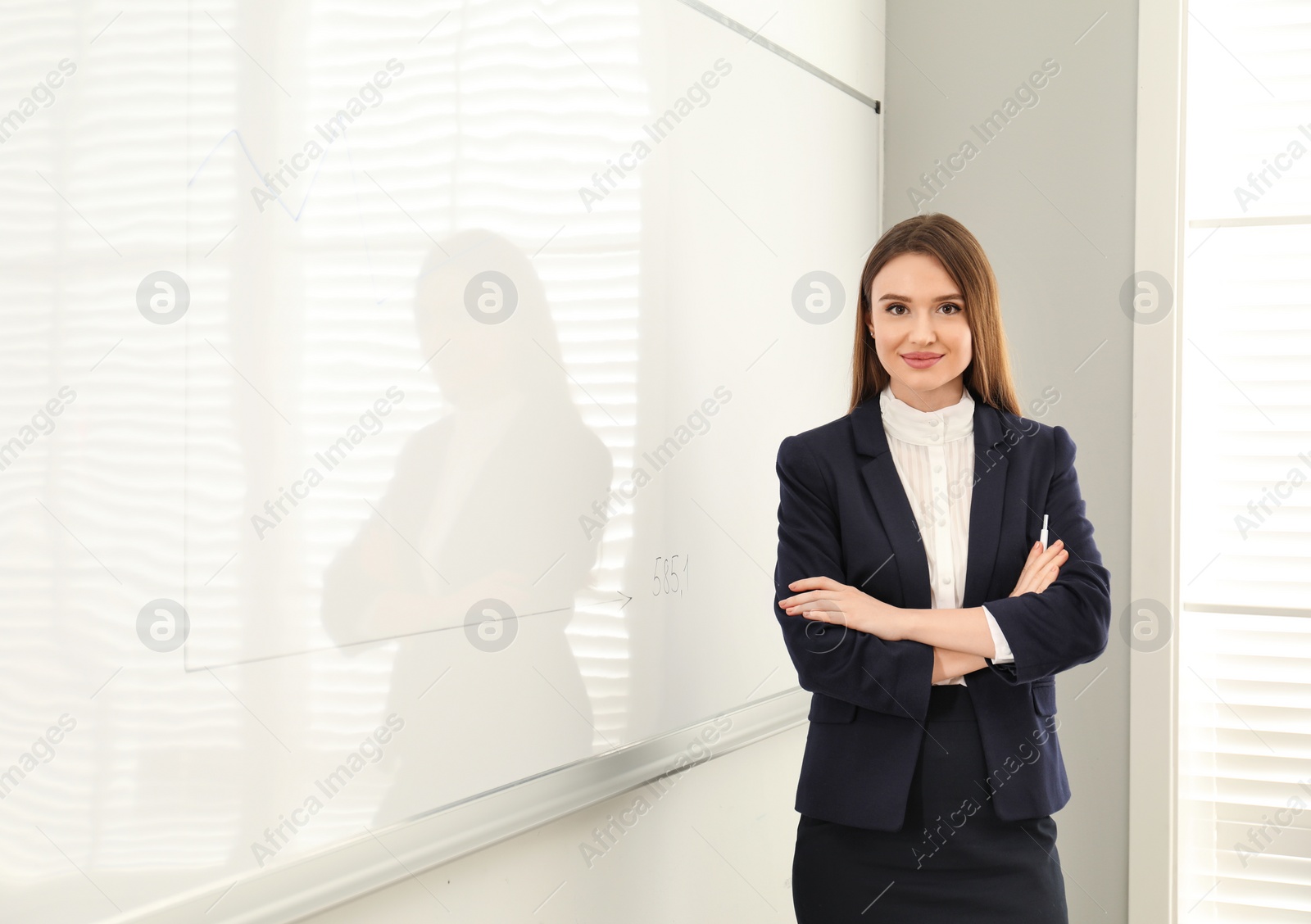 Photo of Professional business trainer near whiteboard in office