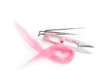 Photo of Pink felting wool, scissors and needles isolated on white, top view