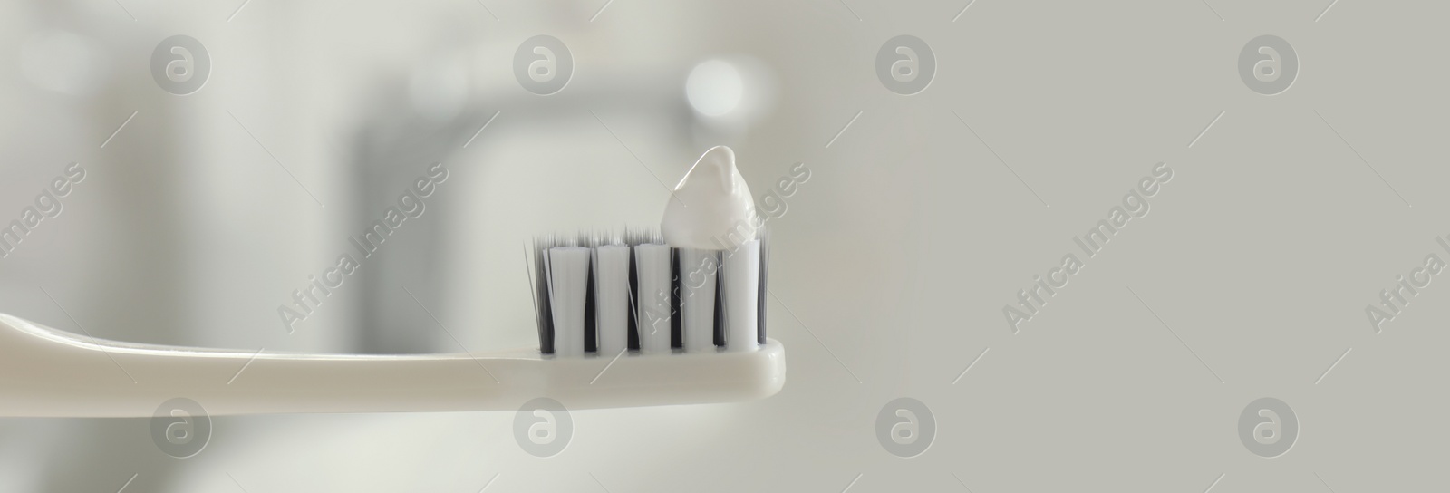 Image of Brush with toothpaste in bathroom, space for text. Banner design