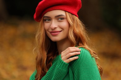 Photo of Portrait of beautiful woman wearing autumn sweater outdoors