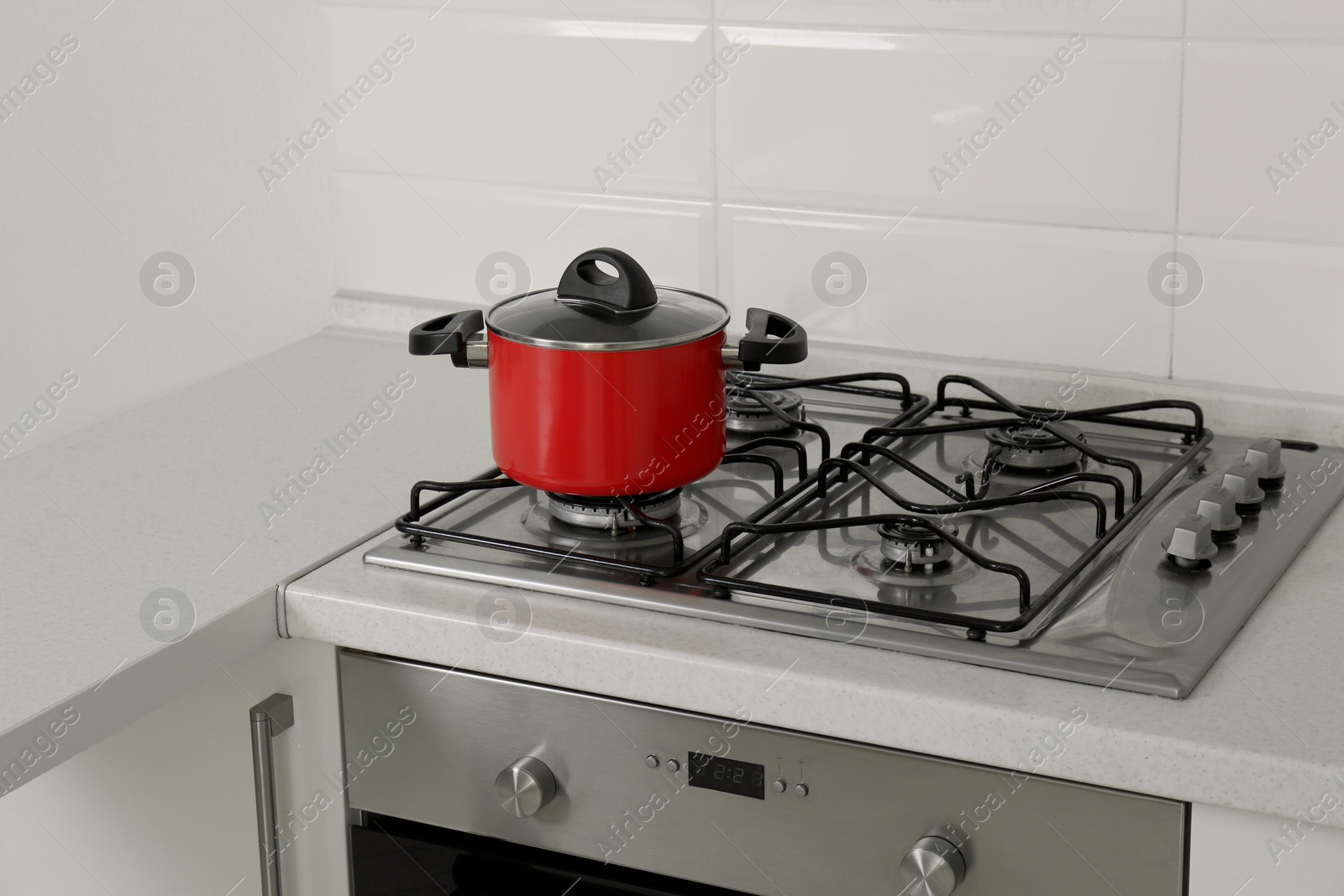 Photo of Red pot on gas stove in kitchen