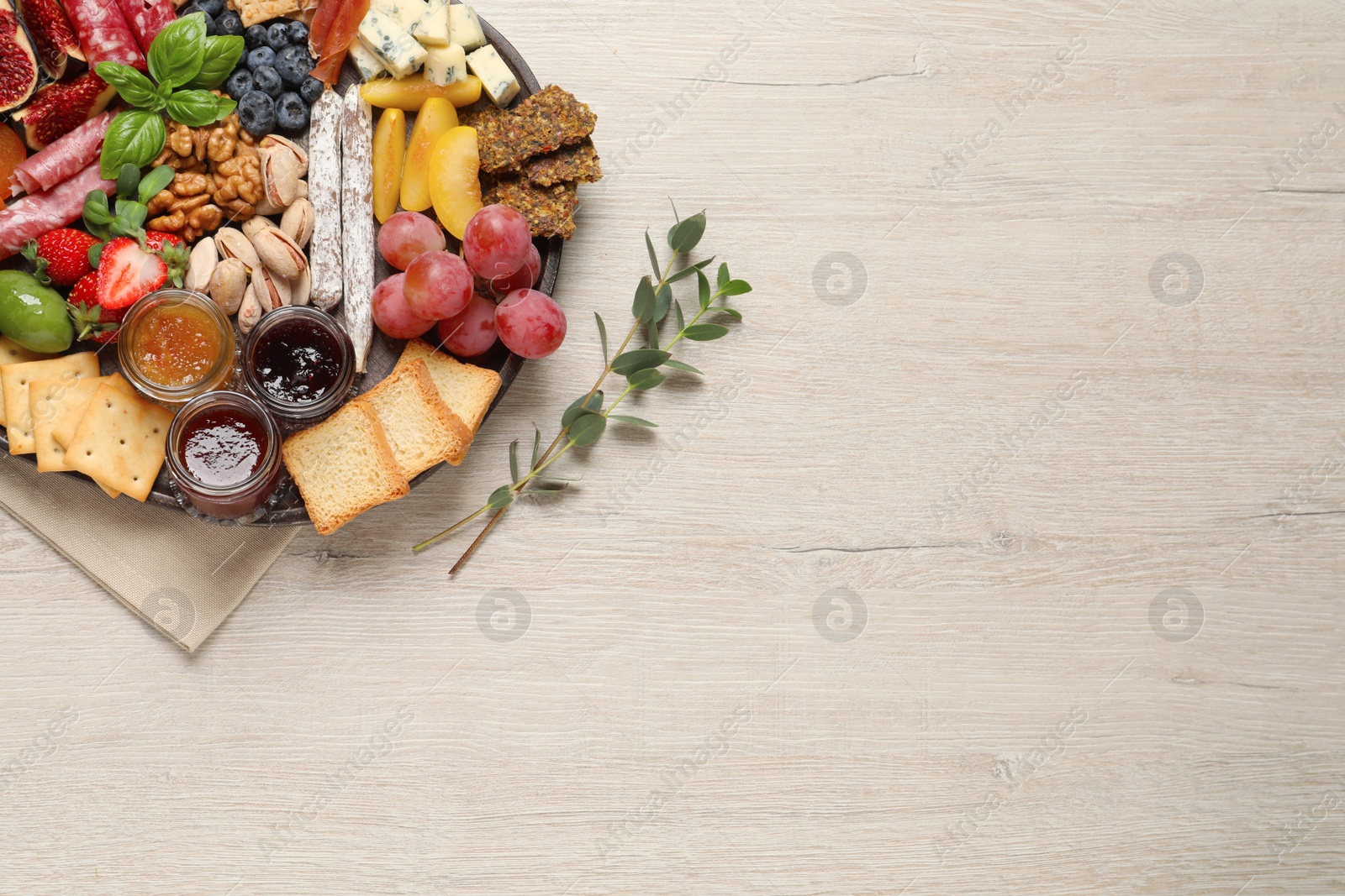 Photo of Different tasty appetizers on wooden table, flat lay. Space for text