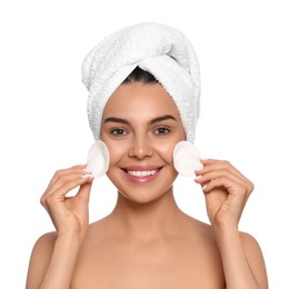 Photo of Young woman using cotton pads with micellar water on white background