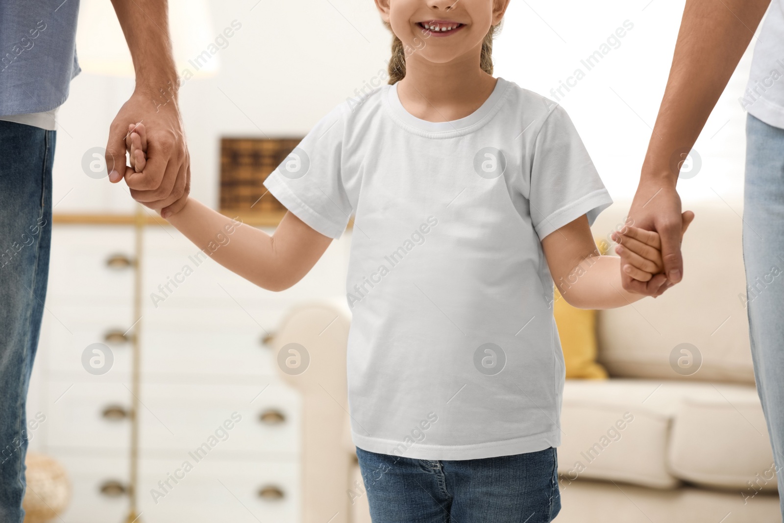 Photo of Happy family holding hands indoors, closeup view