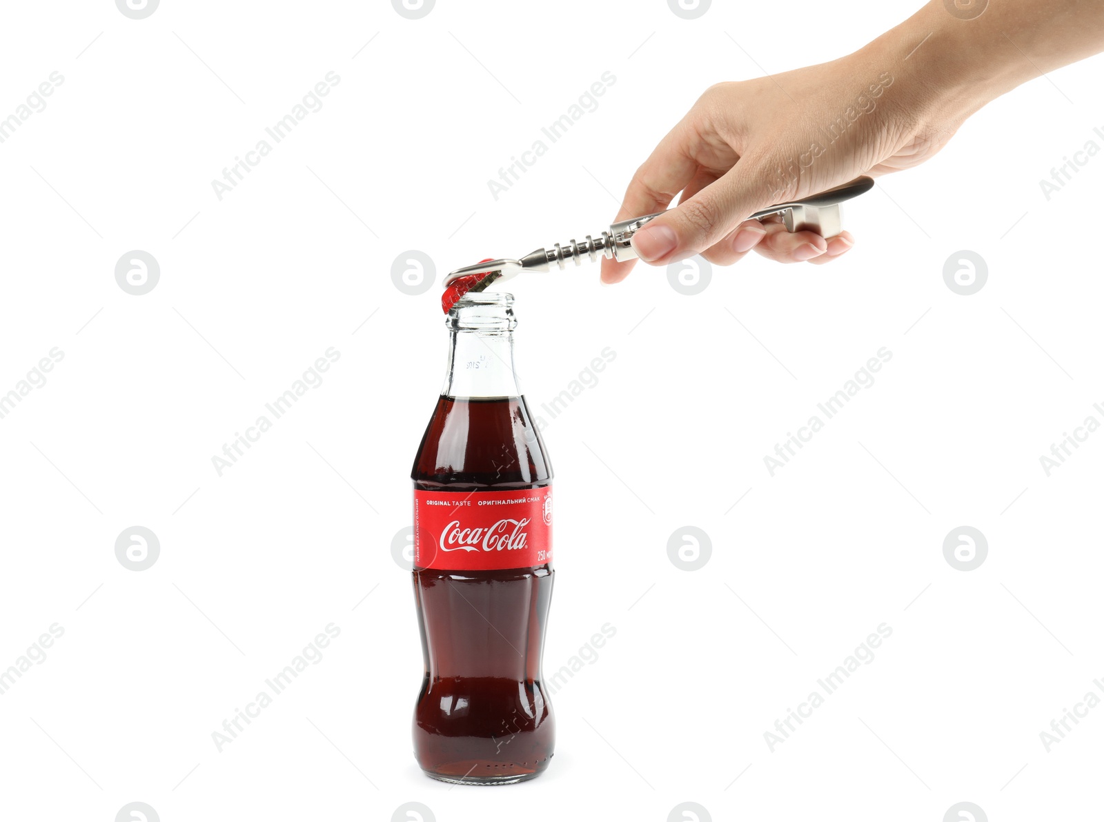 Photo of MYKOLAIV, UKRAINE - NOVEMBER 15, 2018: Woman opening Coca Cola bottle on white background, closeup