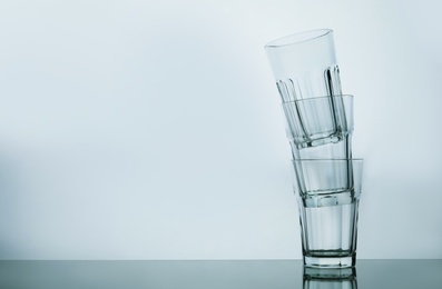 Photo of Stack of empty beverage glasses on white background