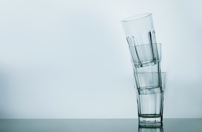 Stack of empty beverage glasses on white background