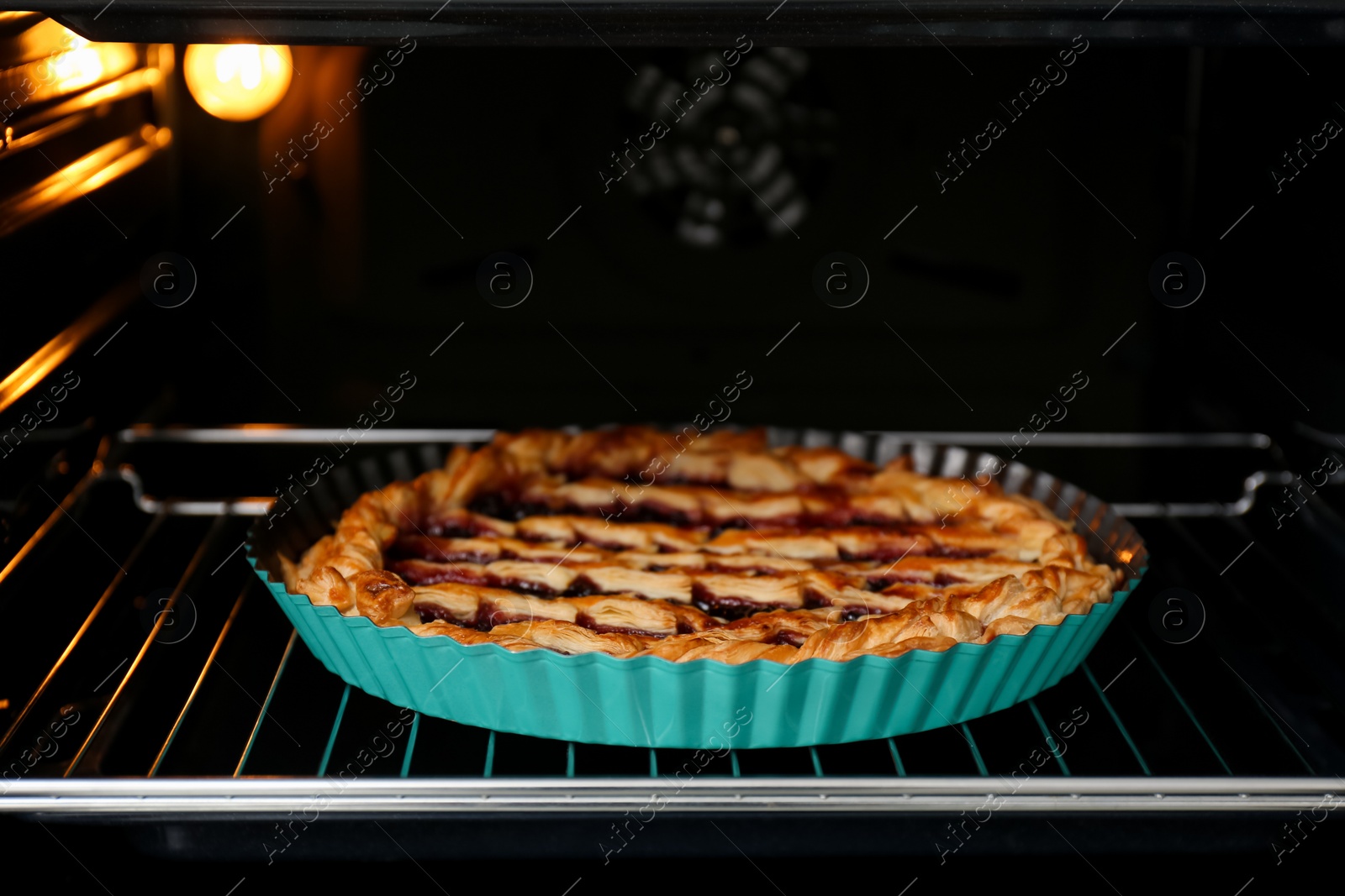 Photo of Delicious fresh homemade cake in oven, closeup