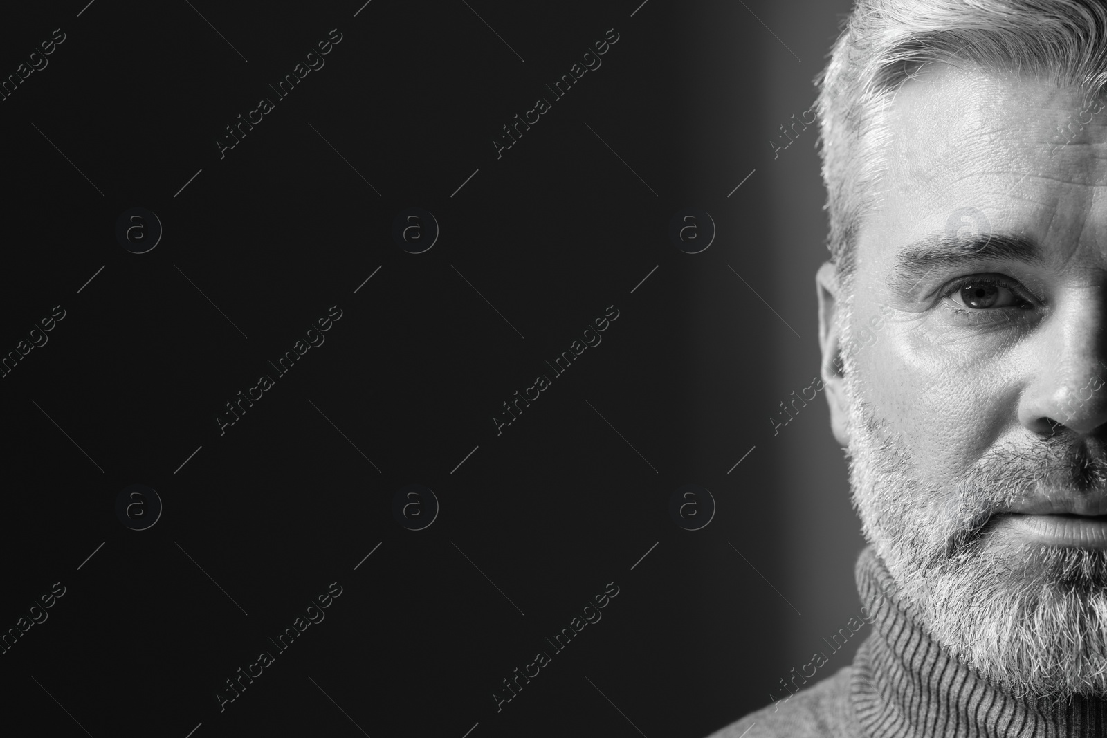 Photo of Portrait of handsome man on dark background, space for text. Black and white effect