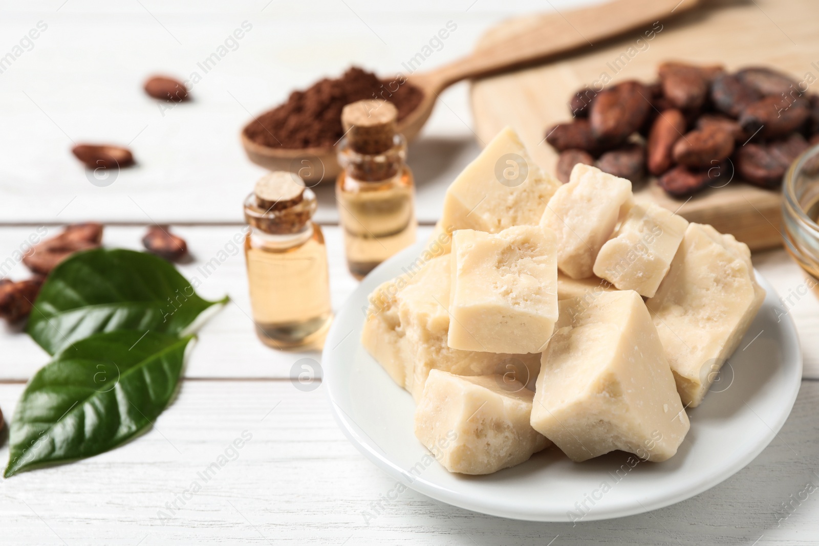 Photo of Organic cocoa butter on white wooden table