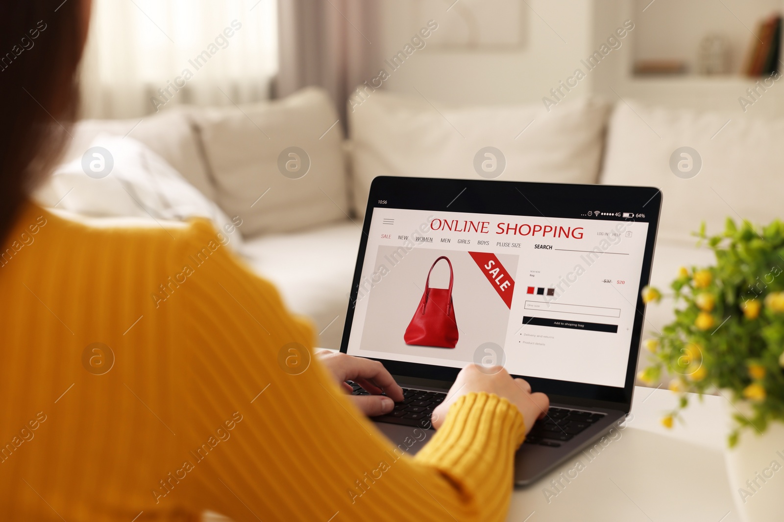 Photo of Woman shopping online during sale on laptop at home, closeup