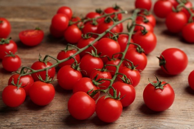 Photo of Fresh ripe cherry tomatoes on wooden table