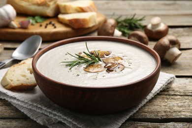 Photo of Fresh homemade mushroom soup served on wooden table