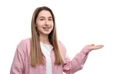 Photo of Portrait of smiling woman with dental braces showing something on white background