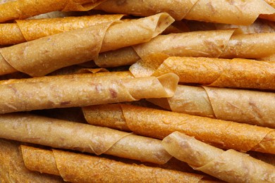 Photo of Delicious fruit leather rolls as background, top view