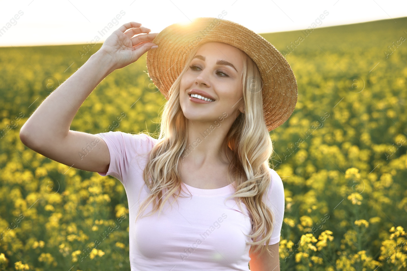 Photo of Portrait of happy young woman in field on spring day