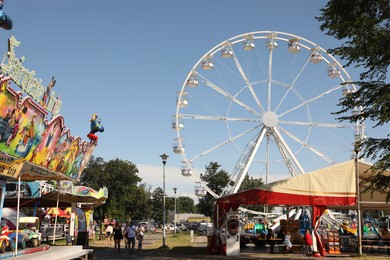 Darlowo, Poland - July 31 2022: Beautiful amusement park with ferris wheel on sunny day