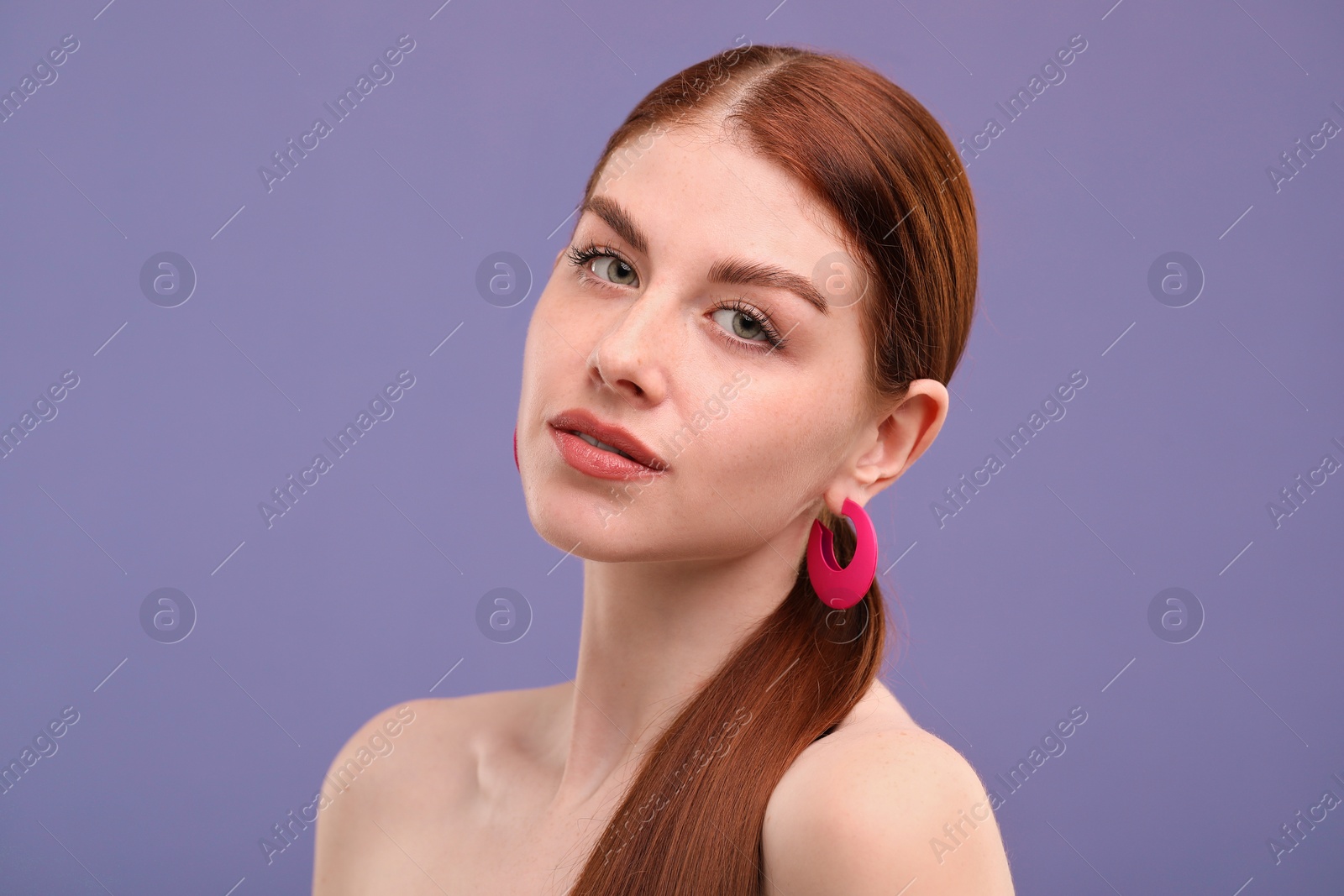 Photo of Portrait of beautiful woman with freckles on purple background