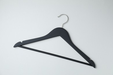 Photo of Empty black hanger on light grey background, top view