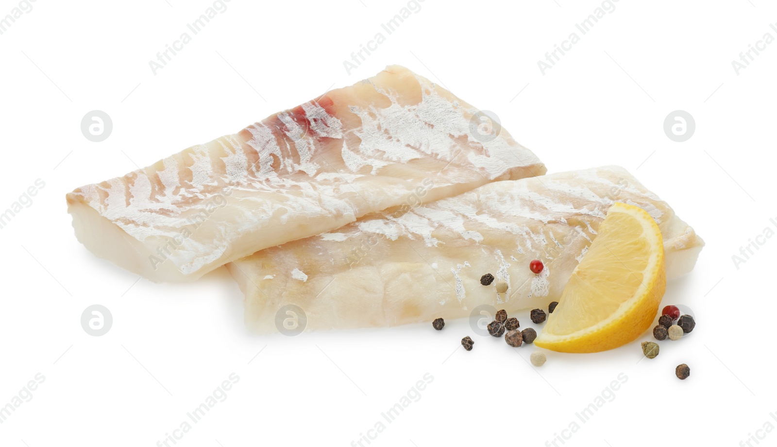 Photo of Fresh raw cod fillets with peppercorns and lemon isolated on white