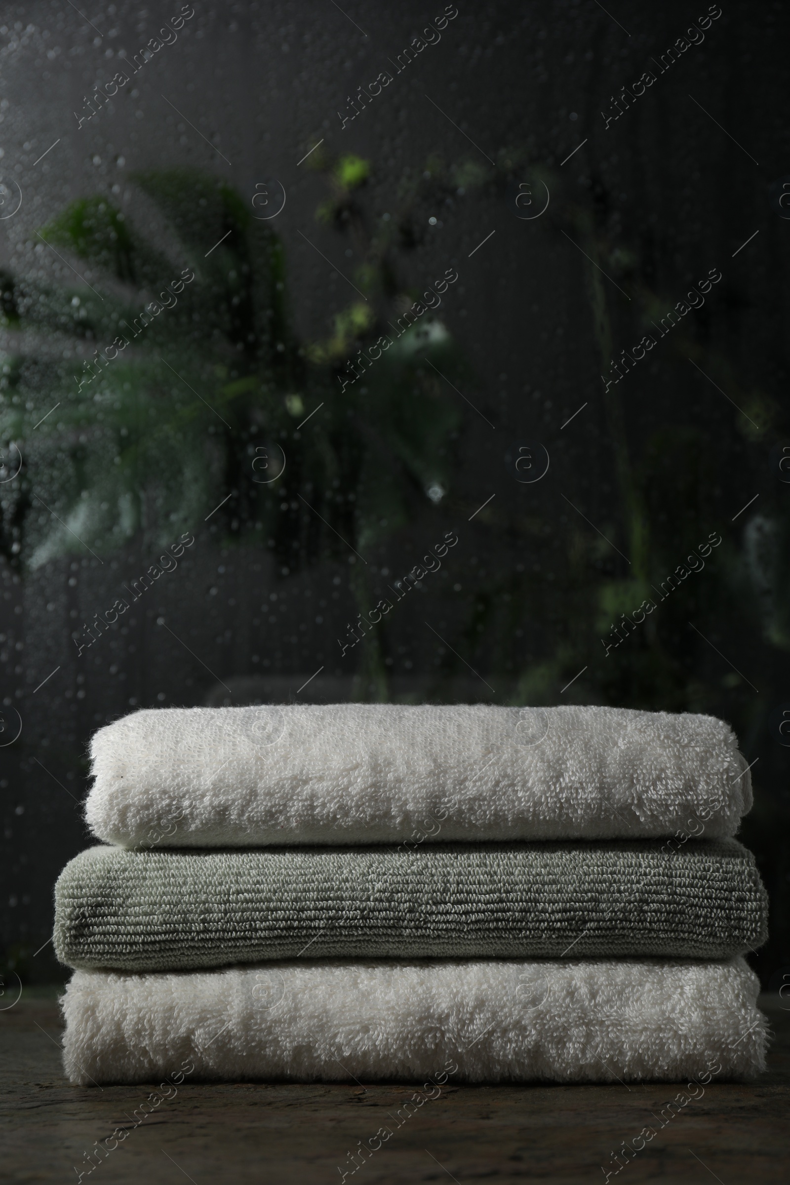 Photo of Stacked terry towels on table in bathroom