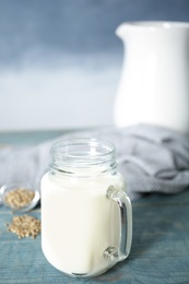 Photo of Mason jar with hemp milk on table